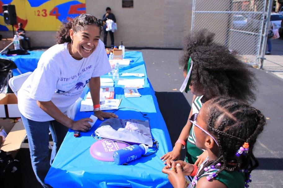Dr. Brown smiles at a table with two children