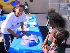 Dr. Brown smiles at a table with two children
